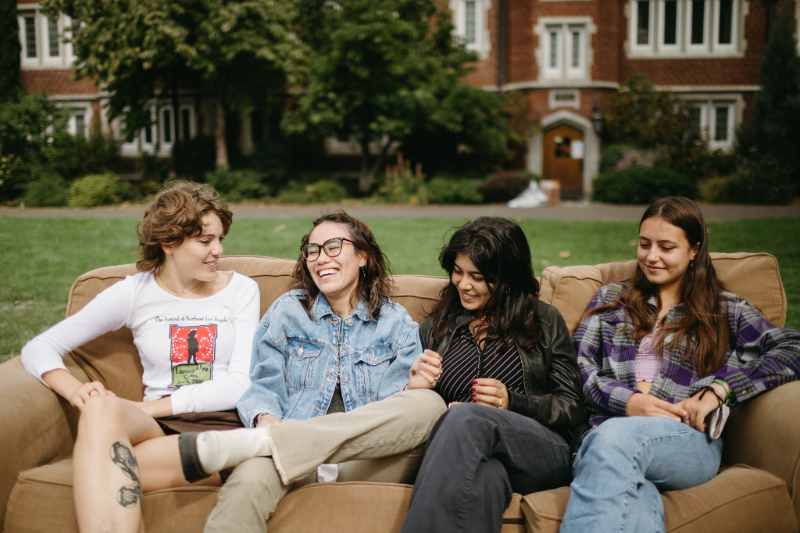 Four students sitting on a couch outside at Reed