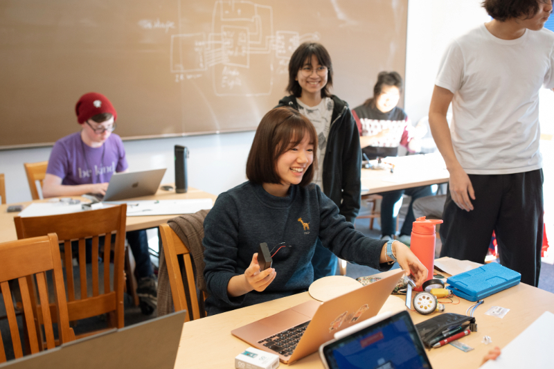 Four students sitting on a couch outside at Reed