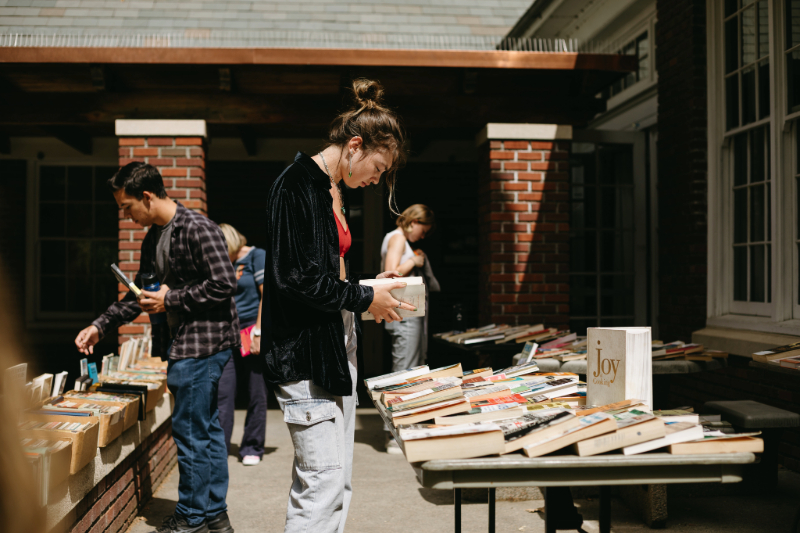 Students looking for books at an outdoor book fair